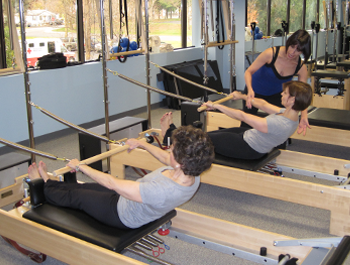 Lynda Capocefalo and client at Absolute Pilates assists a client