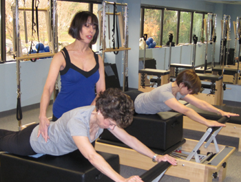 Lynda Capocefalo working with a client at her Absolute Pilates Studio in Albany, New York